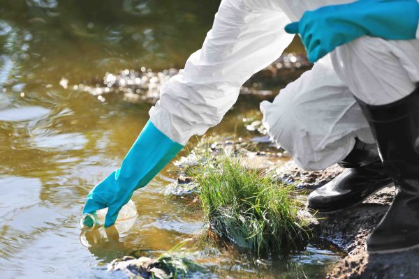 Woman With Flask For Expertise. Environmental Pollution Concept